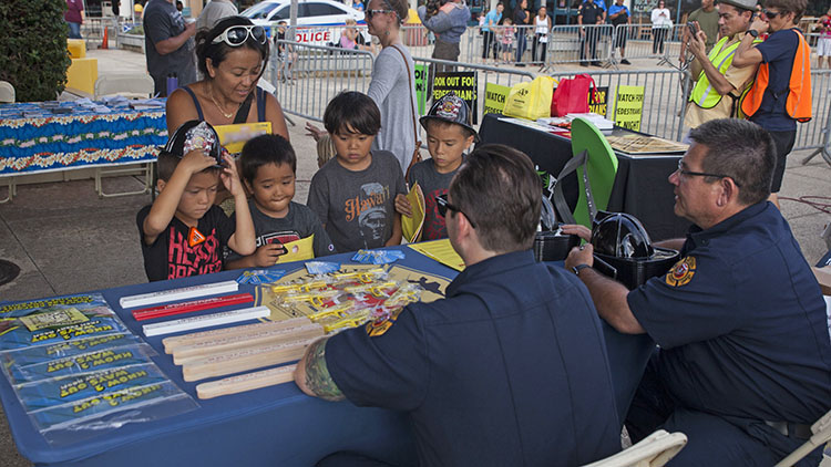 a family talks to a police officer at a tablel