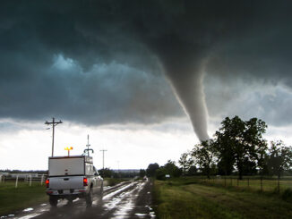 Storm vehicle with the Center for Severe Weather Research driving into the path of tornado, in Katie, Oklahoma.