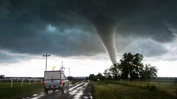 Storm vehicle with the Center for Severe Weather Research driving into the path of tornado, in Katie, Oklahoma.